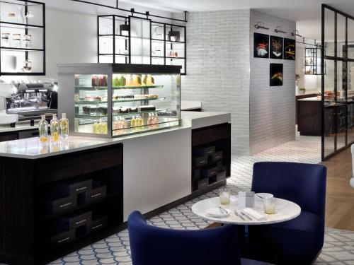 a kitchen with a table and chairs and a counter at Kempinski The Boulevard Dubai in Dubai