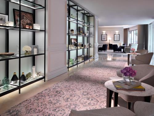 a living room with glass shelves and a lobby at Kempinski The Boulevard Dubai in Dubai