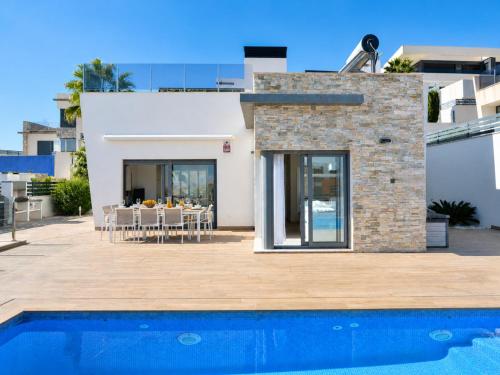 a villa with a swimming pool and a house at Hillside Luxury Villas by NRAS in Finestrat