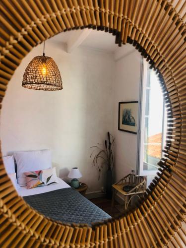 a bedroom with a bed and a large round mirror at la colombe du marais in Courçon