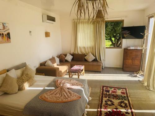 a living room with a bed and a couch at Sisi villa in Essaouira