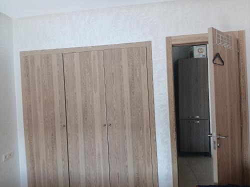 a pair of wooden closet doors in a room at Puerto banus beach Apt Famillies and married couples in Mansouria