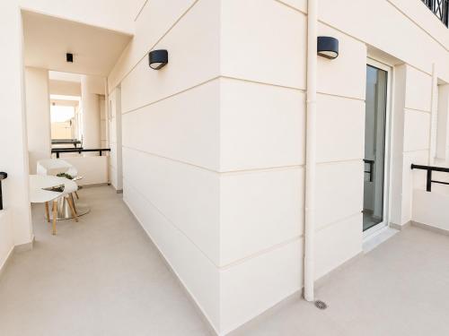 a room with a white wall with shelves at AVENA Suites in Kato Gouves
