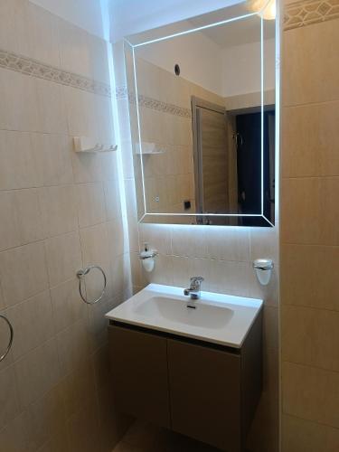 a bathroom with a sink and a mirror at Aura in Scilla