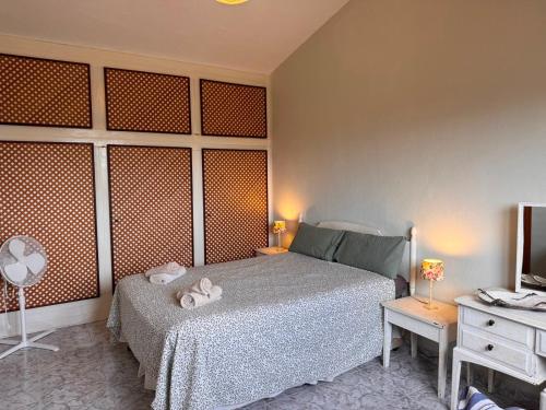 a bedroom with a bed and a desk and a television at Casa Peregil in Perelló