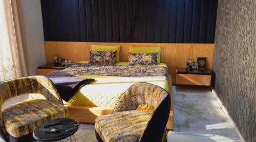 a hotel room with a bed and two chairs at YourHome in Casablanca