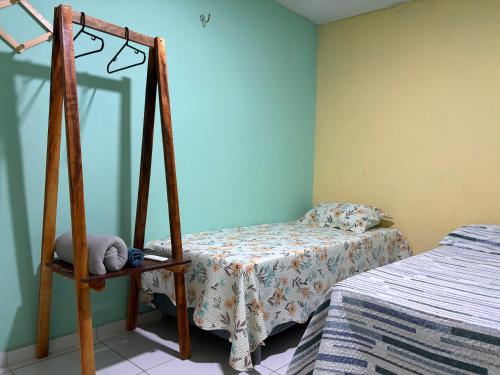 a bedroom with a bed and a mirror on the wall at Quarto Boto Tucuxi in Santarém