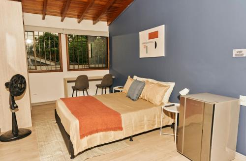 a bedroom with a bed and two chairs in it at Poblado-Aguacatala Apart-Hotel in Envigado