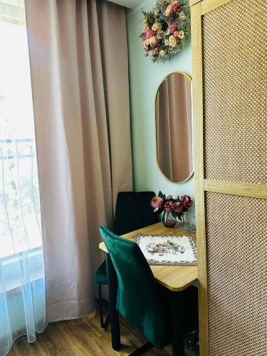 a table in a room with a mirror and a table with a chair at Pienińska Róża in Szczawnica