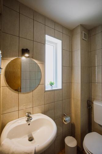 a bathroom with a sink and a window at Artelo - Inspired Stay in Bitola