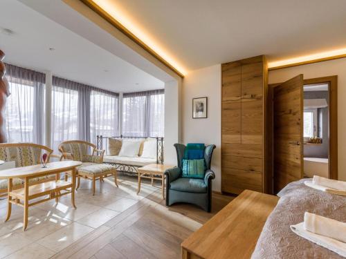 a hotel room with a bed and a table and chairs at Premium Mountain View Suite in Kirchberg in Tirol