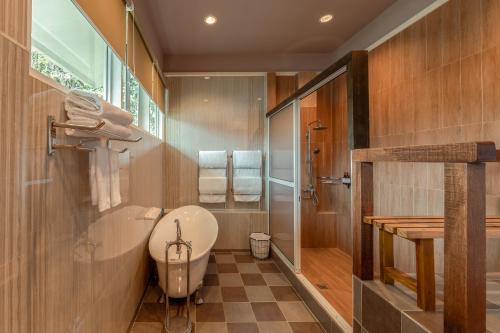 a bathroom with a toilet and a sink and a shower at Sutera Sanctuary Lodges At Kinabalu Park in Kampong Kundassan