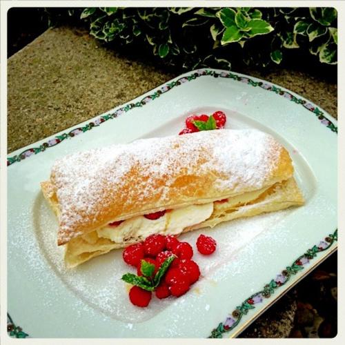 a white plate with a sandwich with strawberries on it at Penzion V polích in Malé Číčovice