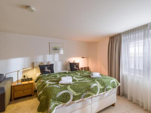 a bedroom with a large bed and a window at Studio mit Lounge in Kirchberg in Tirol