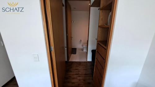 a hallway leading into a room with a bathroom at QBICo Santa Fe Condominium in Mexico City