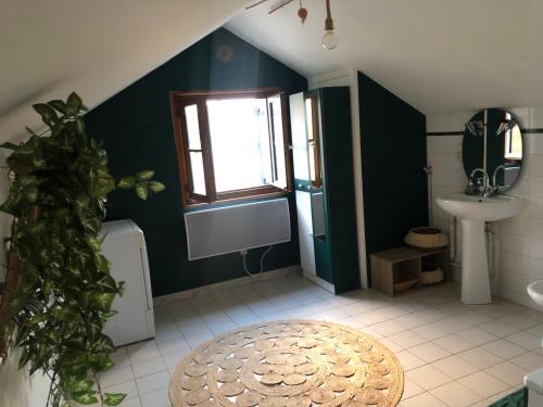 a bathroom with a sink and a toilet and a window at Gite Fée Grenouille in Martigny-le-Comte