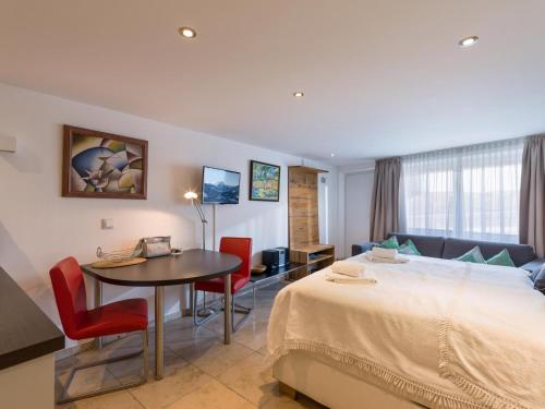 a hotel room with a bed and a table and chairs at Studio mit Sauna in Kirchberg in Tirol