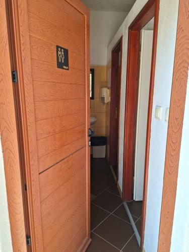 a door leading to a hallway with a bathroom at Camp Oblica - parcela - empty plot in Pirovac
