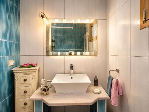 a bathroom with a sink and a mirror at Casa Adam and spa in Zakynthos