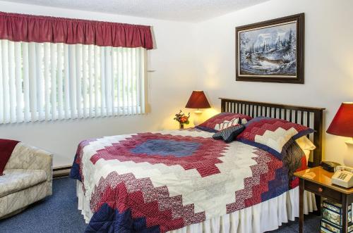 a bedroom with a bed with a quilt on it at Nordic Inn Condominium Resort in Lincoln