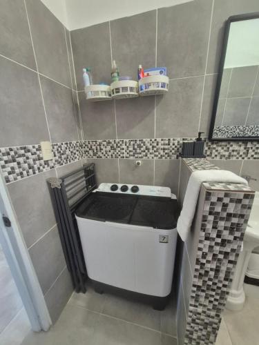 a small kitchen with a stove in a bathroom at OMY Apartments Nagua 2A in Nagua