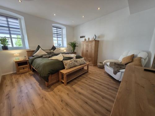 a bedroom with a bed and a couch at Rosenzauber Seeromantik "Kramer" in Weißenstadt