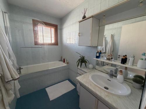 a white bathroom with a sink and a tub and a sink at Tredd in La Rochelle