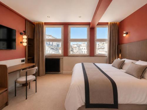 a hotel room with a bed and a desk and window at 336 Saint-Honore By Chapitre Collection in Paris