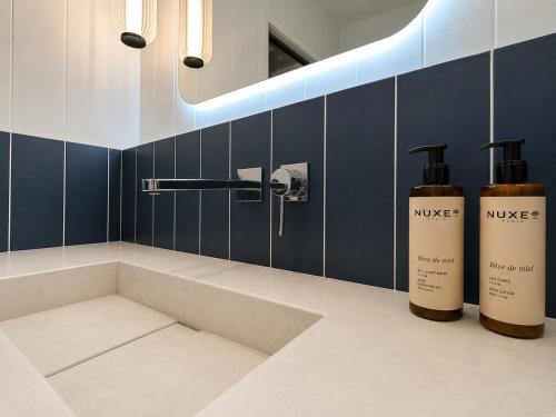 a bathroom with two bottles of nike products on a counter at 336 Saint-Honore By Chapitre Collection in Paris