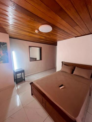 a bedroom with a bed and a wooden ceiling at Casa solarte bocas del toro in Bluff BEach