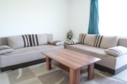 a living room with two couches and a coffee table at Cherry Apartments in Sarajevo