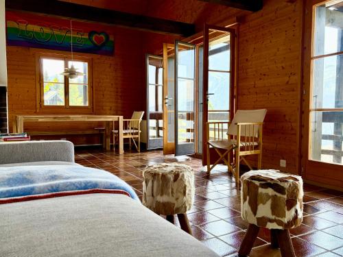 a bedroom with two beds and a table and chairs at Beautiful chalet with exceptional views, very quiet in Gryon