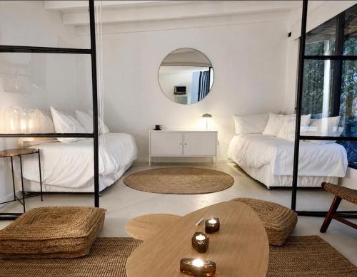 a living room with two beds and a table at Glaciar de Roca Lofts in Horcon