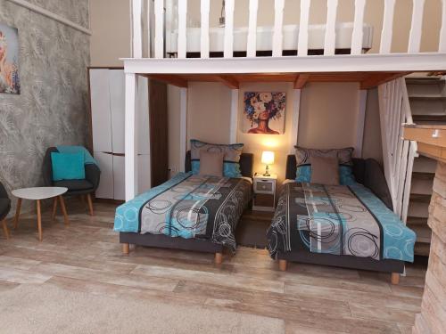 two beds in a room with a bunk bed at Edina Apartman in Sátoraljaújhely