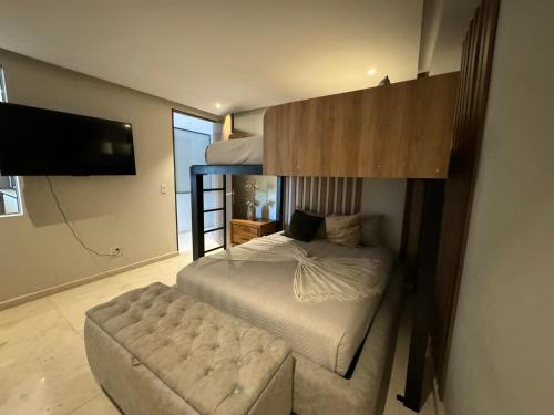 a bedroom with a bunk bed and a stool at Departamento Brisa del Mar Punta Mita, Beach Front in Bucerías
