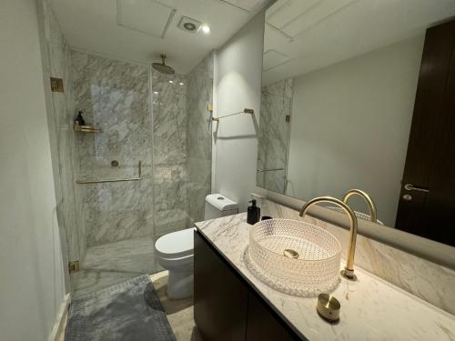 a bathroom with a sink and a toilet and a shower at Departamento Brisa del Mar Punta Mita, Beach Front in Bucerías