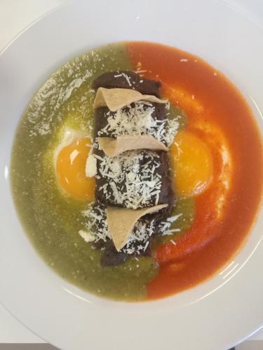a bowl of soup with eggs and other ingredients at Hotel Star Express Puebla - Central CAPU in Puebla