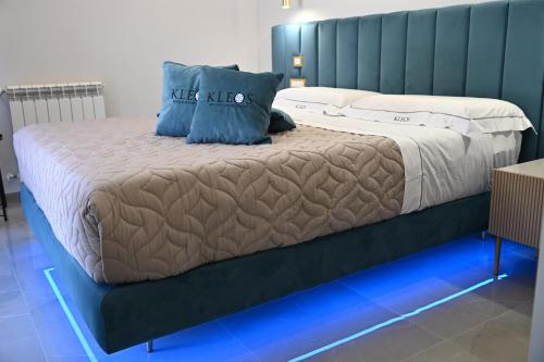 a bedroom with a bed with blue lights on it at Kleos Luxury Rooms in Porto Empedocle