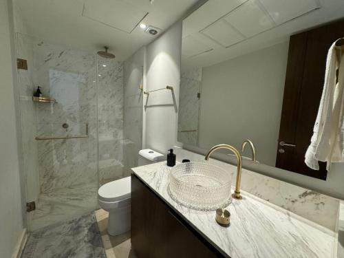 a bathroom with a sink and a toilet and a shower at Departamento Playa Dorada Punta Mita, Beach Front in Punta Mita