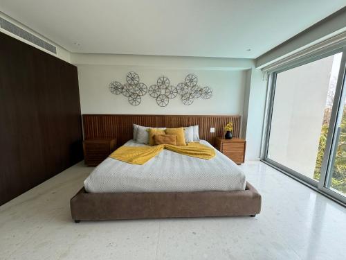a bedroom with a bed and a large window at Departamento Playa Dorada Punta Mita, Beach Front in Punta Mita