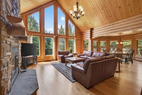 a large living room with a couch and a tv at Fiddler Lake Resort - Deer 48 in Mille-Isles