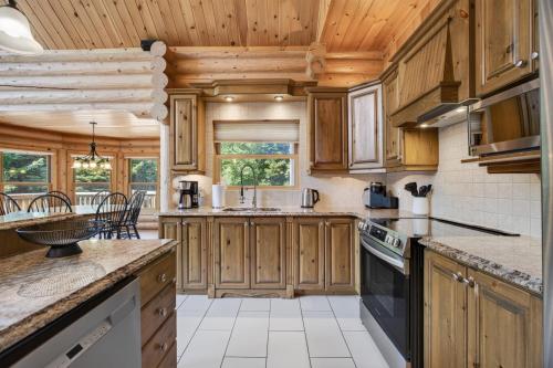 a kitchen with wooden cabinets and a counter top at Fiddler Lake Resort - Deer 48 in Mille-Isles