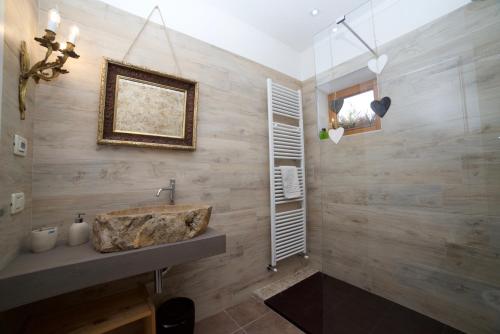 a bathroom with a sink and a wooden wall at A&B Le Terrazze del Sale' - Apartments in Trento