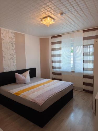 a bedroom with a bed and a chandelier at Marina in Bleckede