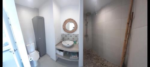 a white bathroom with a sink and a mirror at TORRES DEL SOL A 50 metros playa las vistas in Playa de las Americas