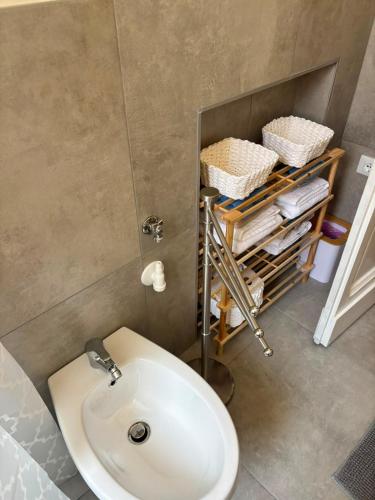 a bathroom with a white toilet and a sink at Casa Dolce Casa in Guardiagrele