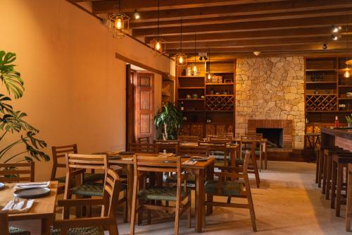 a dining room with tables and chairs and a fireplace at Casa del Alma Hotel Boutique & Spa in San Cristóbal de Las Casas