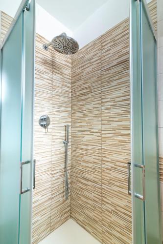 a bathroom with a shower with a glass door at Poseidonia nel Borgo in Pulsano