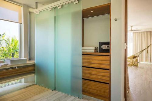 a glass shower door in a bathroom with a sink at Villa 34 I Puerto Aventuras I Private Pool in Puerto Aventuras