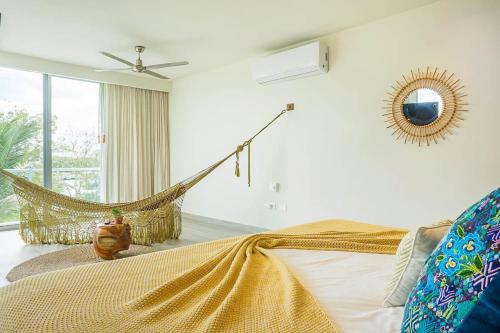 a bedroom with a bed and a hammock at Villa 34 I Puerto Aventuras I Private Pool in Puerto Aventuras